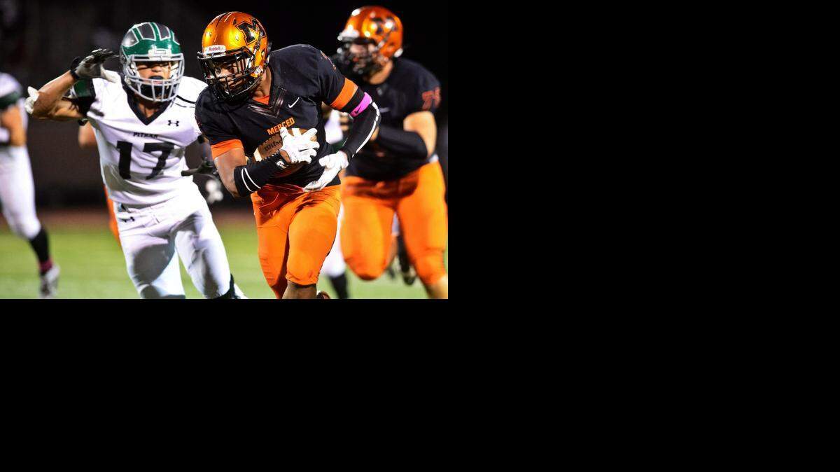 
Merced High senior running back Jabar Byrd (2) rushes up the middle of the field during a game against Pitman at Golden Valley High School in Merced, Calif., Friday, Oct. 17, 2014.
