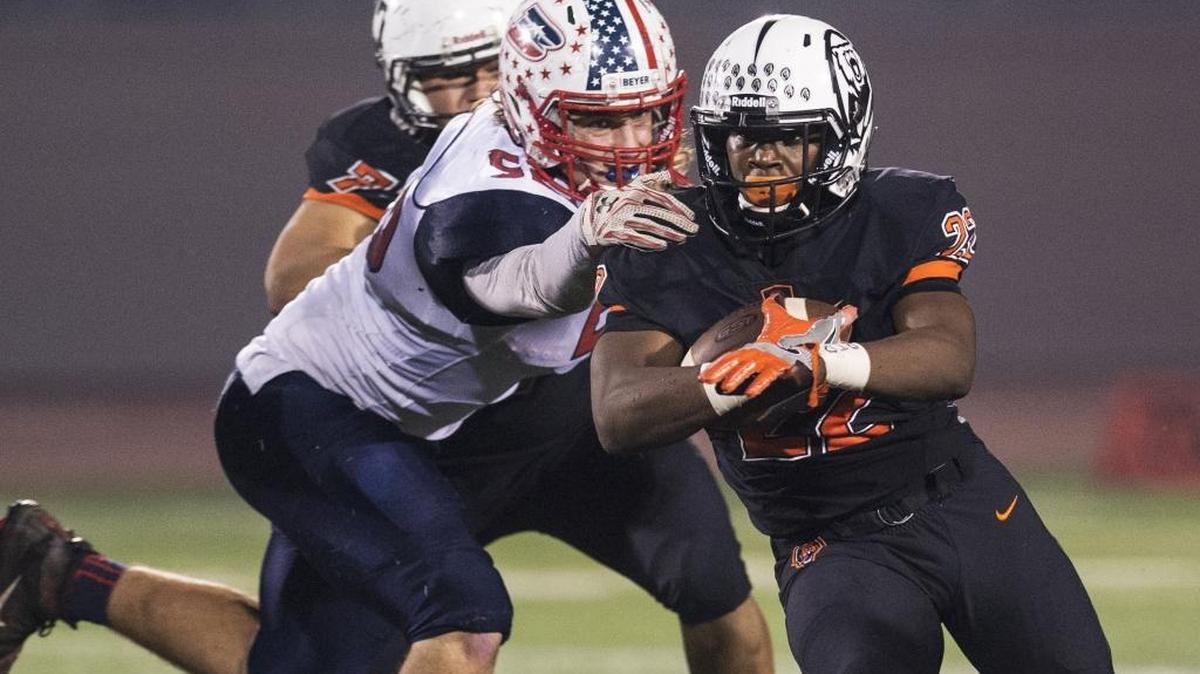 Merced senior running back Rayveon Slaton sprints past a Beyer defender in Merced on Thursday, Nov. 10, 2016.