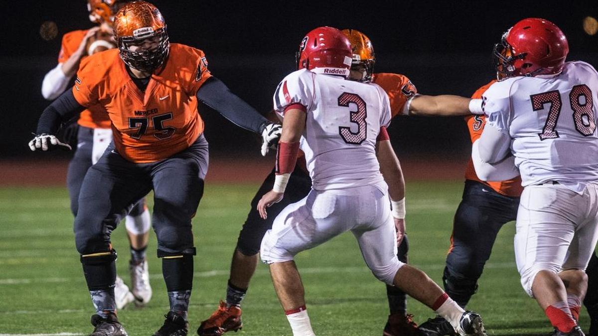 Merced senior offensive lineman Joe Moraga (75) blocks during a playoff game against Modesto at Veterans Stadium in Merced, Calif., on Friday, Nov. 13, 2015.