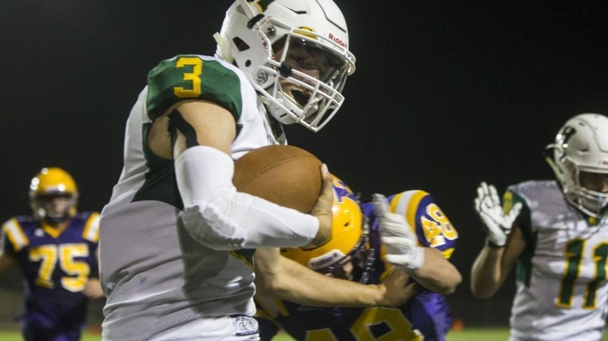 Hilmar High's Chase Kindberg (3) get hit out of bounds during play against Escalon High Football at Escalon High Friday Oct. 7, 2016.