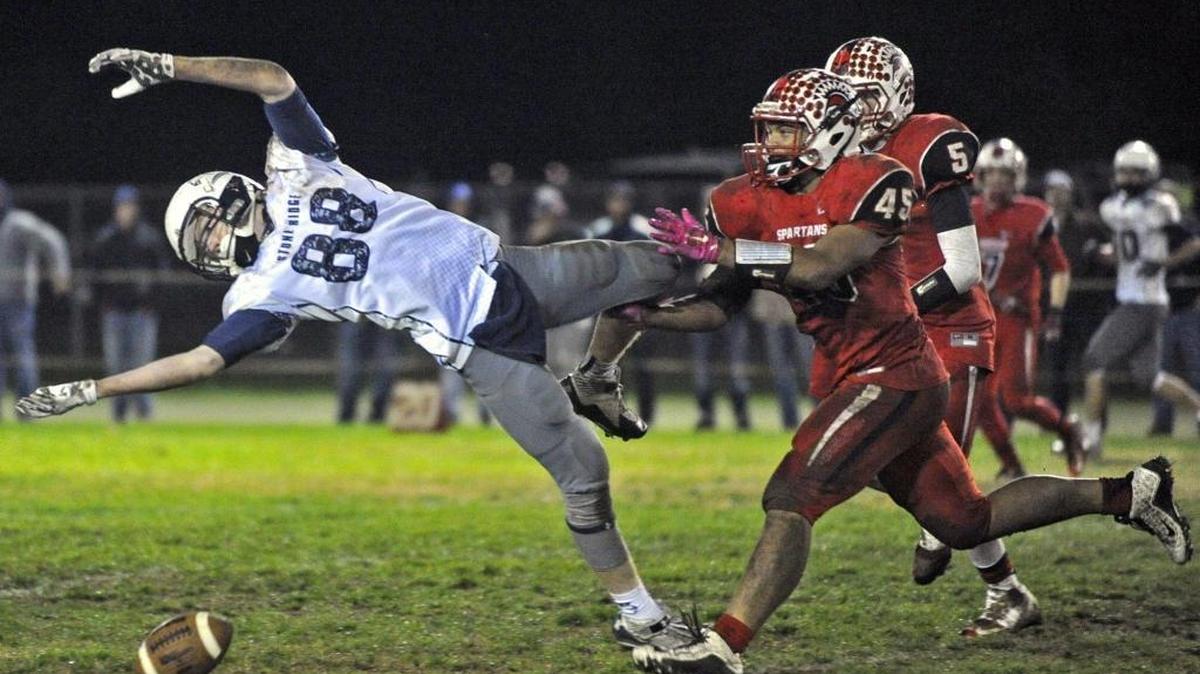 Stone Ridge Christian tight end Austin Houweling watches a fourth down pass fall to the turf as East Nicolaus linebacker Donavan Switalski closes in during the Knights' 34-14 loss in the CIF Northern California Regional Division VI-AA bowl game at Wahl Field in Trowbridge, Friday, Dec. 11, 2015.