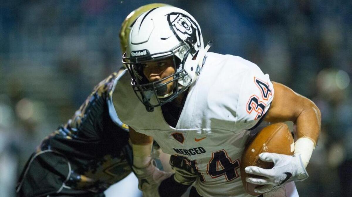 Merced senior running back Ulonzo Gilliam Jr. (34) turns upfield during a game against Buhach Colony at Atwater High School in Atwater, Calif., Friday, Oct. 21, 2016. The Bears beat the Thunder 42-13.