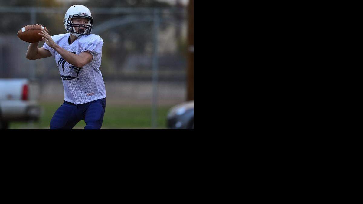 
Stone Ridge Christian senior quarterback Luke Lange (15) drops back to pass during football practice in Merced, Calif., Wednesday, Nov. 19, 2014.
