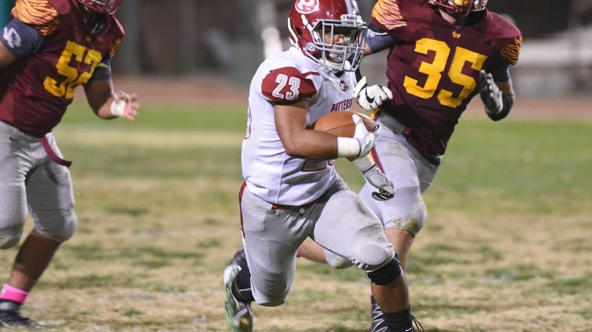 Patterson High School running back, Phabian Portillo evades two Los Banos High players in the fourth quarter Fri, Oct. 20, 2017 at Loftin Stadium in Los Banos.