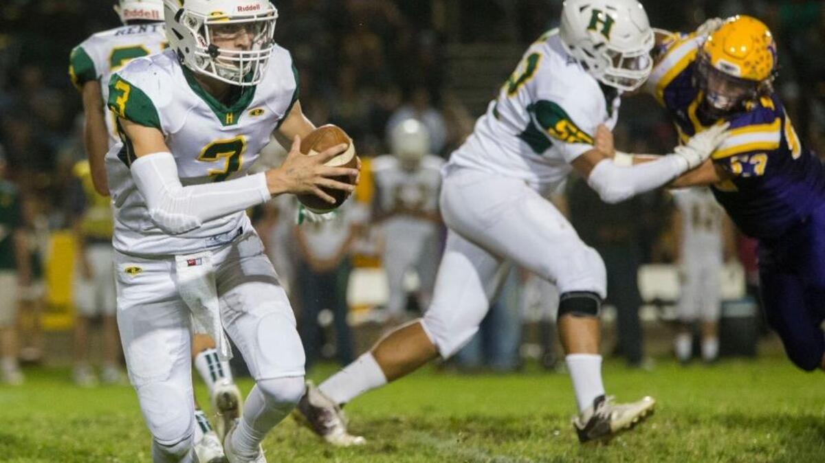 Hilmar High’s Chase Kindberg (3) looks for an open man during play against Escalon High Football at Escalon High Friday Oct. 7th 2016.