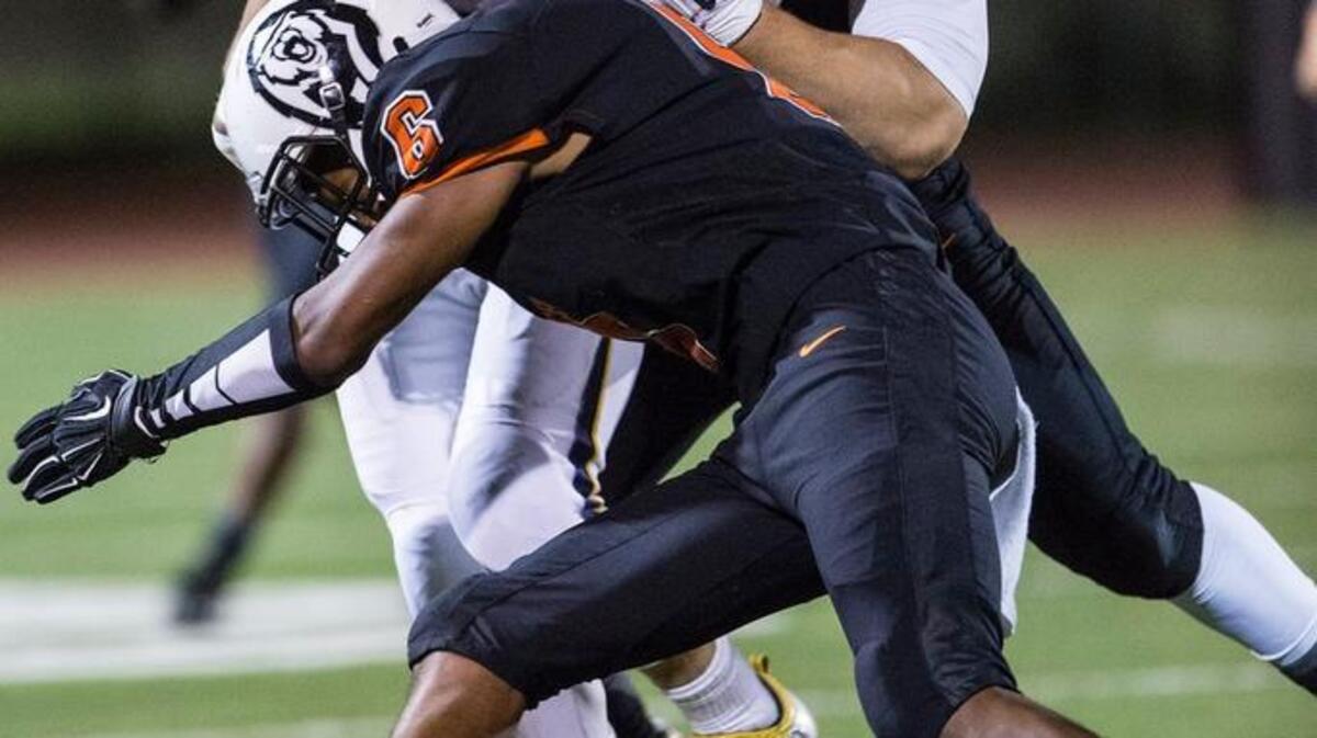 Gregori senior Adrian Leal (1) is tackled by Merced senior linebacker Dustin James (42) and Merced senior Paul Scoggins during a game at Veterans Stadium on the campus of Golden Valley High School in Merced, Calif., Friday, Sept. 2, 2016. The Bears beat the Jaguars 31-14.
