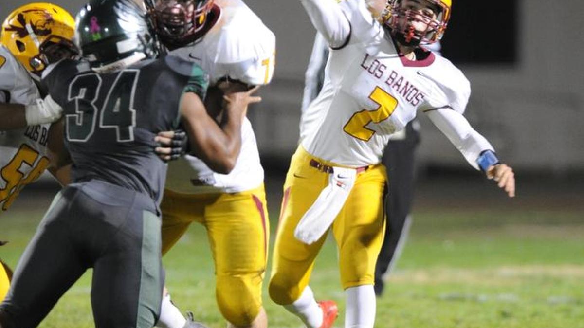 Los Banos quarterback Adam Herrera attempts a pass Fri., Nov. 20, 2015 in Galt against Liberty Ranch.