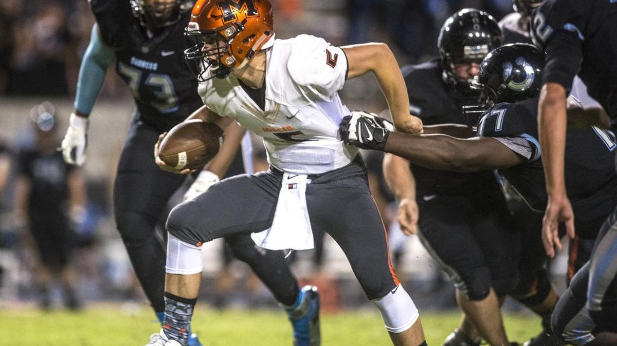 Merced junior quarterback Jacob Foss (5) scrambles out of the pocket during a game against Clovis North at Veterans Memorial Stadium in Clovis, Calif., Thursday, Sept. 24, 2015. Foss is expected to start tonight against Modesto after sitting out the second half last week against Golden Valley with an injured shoulder.