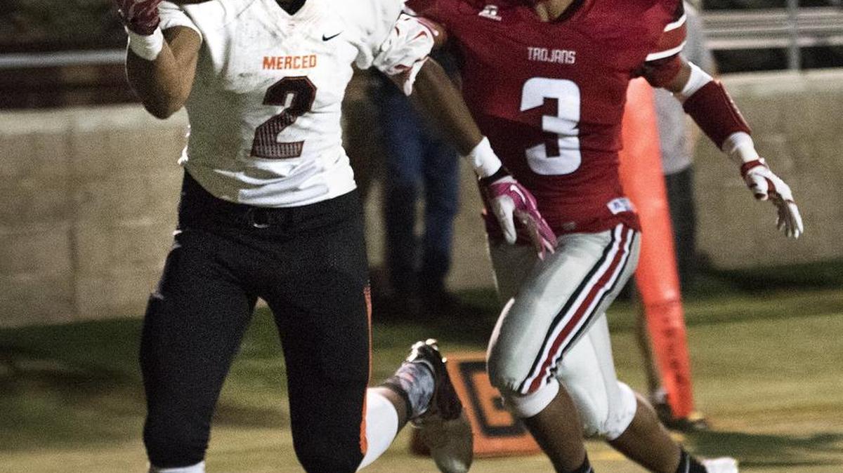 
Merced receiver A.J. Stewart makes a one-handed grab as Lincoln's Justin Watson trails during the non-conference game at Lincoln High School in Stockton, Calif., on Friday, October, 2, 2015. Merced won the game 33-20.
