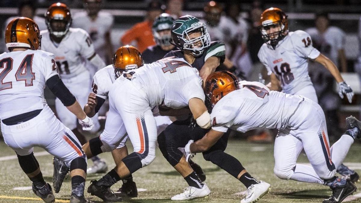 
Merced junior defensive end John Becerra (4) and senior linebacker Marco Granados (44) tackle Pitman junior running back Devan Bass (15) during a game at Joe Debely Stadium in Turlock, Calif., Friday, Oct. 16, 2015. The Bears beat the Pride 28-21.
