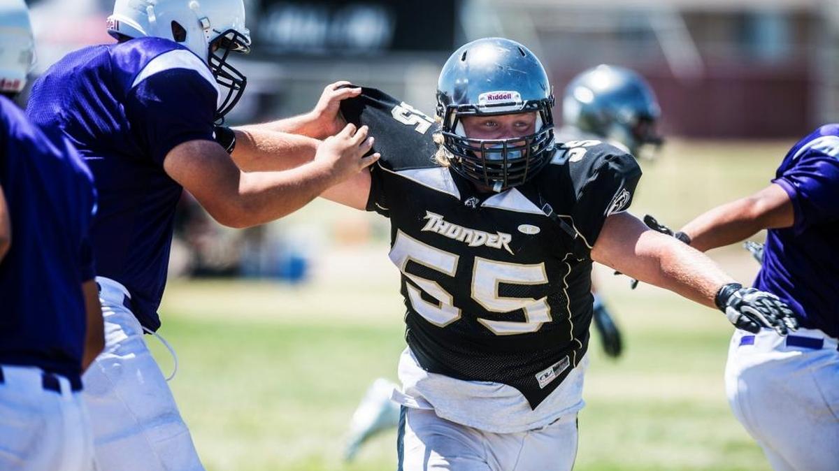 Buhach Colony alum Hunter Stefani (55) breaks through the offensive line during the 2015 Buhach Colony Football Camp. The camp was discontinued this season because of lack of interest resulting from this summer’s no-contact rules.