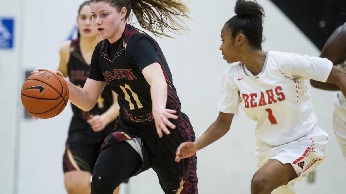 Golden Valley junior Delia Moore (11) dribbles past Merced sophomore Amaya Ervin (1) during a game at Merced High School in Merced, Calif., on Tuesday, Feb. 14, 2017. The Bears beat the Cougars 48-40.