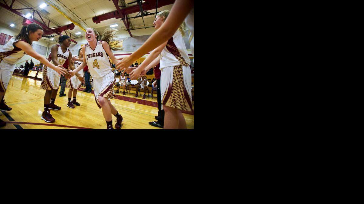 
Stephanie Moore exchanges greetings with Golden Valley teammates as she takes the court before a game against Atwater. Last season, she played for state champion Modesto Christian.
