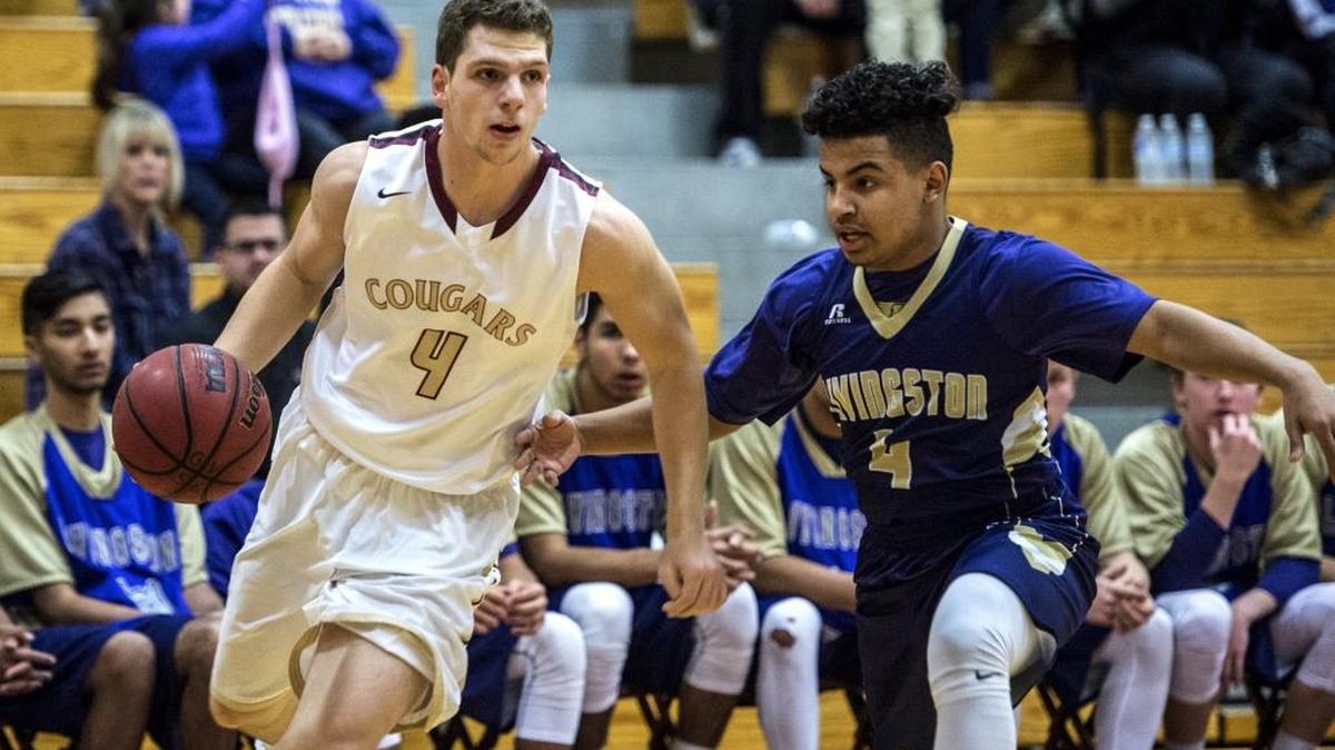 Golden Valley senior Collin Hayes attempts to get around Livingston sophomore Kevin Alvarez during a game at Golden Valley High School in Merced on Monday, Dec. 7, 2015.