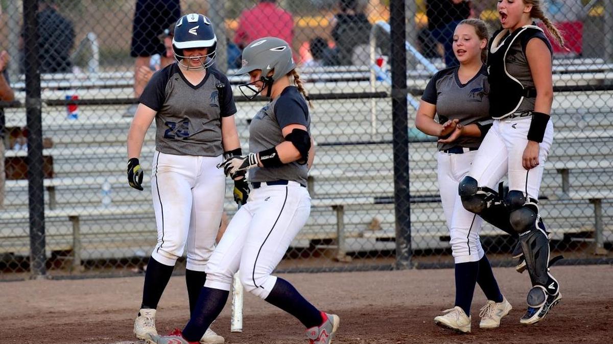 Stone Ridge Christian's Eleanor Nelson, center, touches home plate after hitting a solo home run in the first inning on Tuesday night. Tuesday, May 23, 2017 in Stockton.
