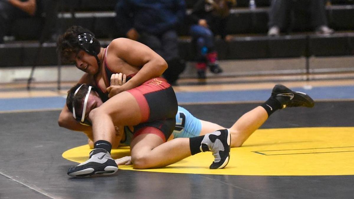 Los Banos' Paul Reyes, top, puts a headlock on El Capitan's Lucas Horoe during Wednesday's dual. Reyes secured a major victory in the 170-pound bout.