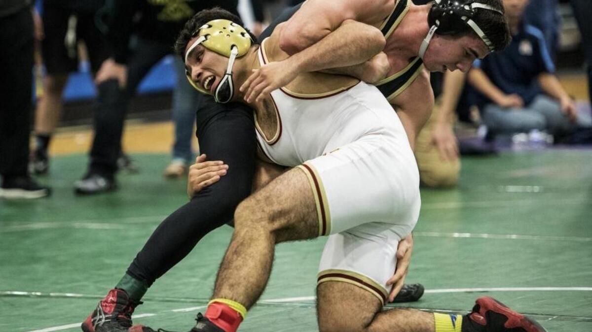 Golden Valley's Johnny Martinez, bottom, wrestles Buhach Colony's Ben Moran, top, during the Central California Conference Wrestling Tournament at Atwater High School in Atwater, Calif., Thursday, Feb. 11, 2016. Martinez beat Moran to win the match.