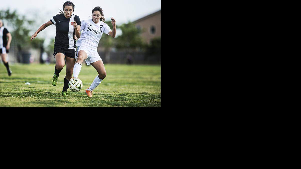 
Merced senior Justine Ramos (2) attempts to steal the ball from Merced senior Hannah Esquivel (9) during a game at Buhach Colony High School in Atwater, Calif., Tuesday, March 24, 2015. The Bears beat the Thunder 3-0.
