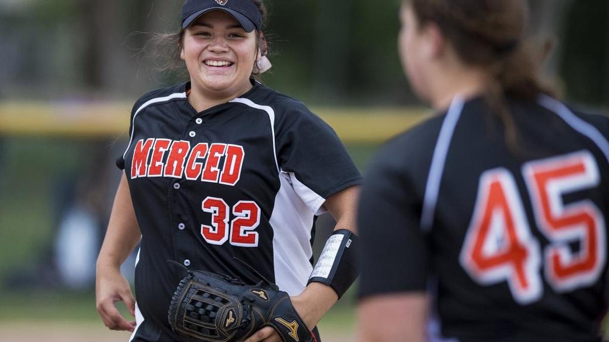 Merced sophomore pitcher Abby Flores (32) smiles to freshman first baseman Kat Arceo (45) after the final out of the game against Golden Valley at Merced High School in Merced, Calif., on Thursday, April 6, 2017. The Bears beat the Cougars 4-0.