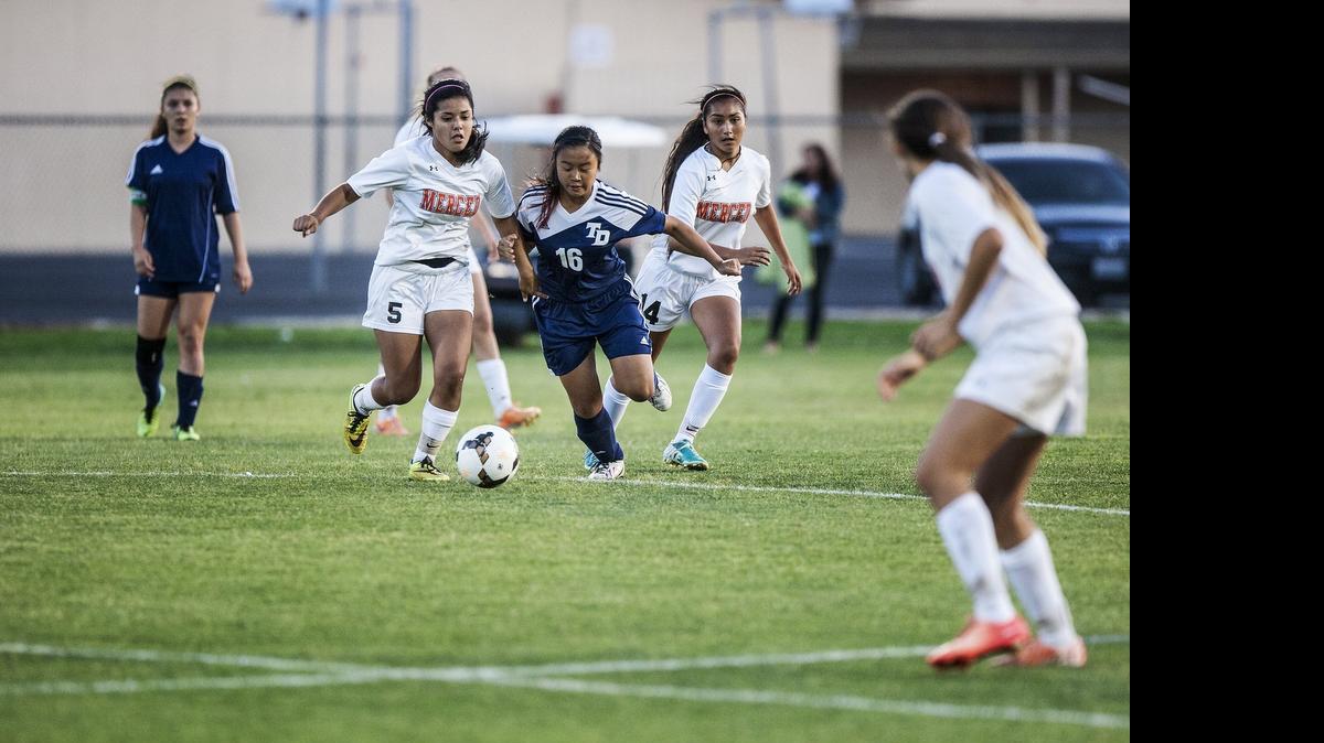 
Merced sophomore Jovanna Salazar (5) fights for the ball with Downey sophomore Rattana Phoutharath (16) during a game at Merced High School in Merced, Calif., Tuesday, May 5, 2015. The Knights beat the Bears 1-0.
