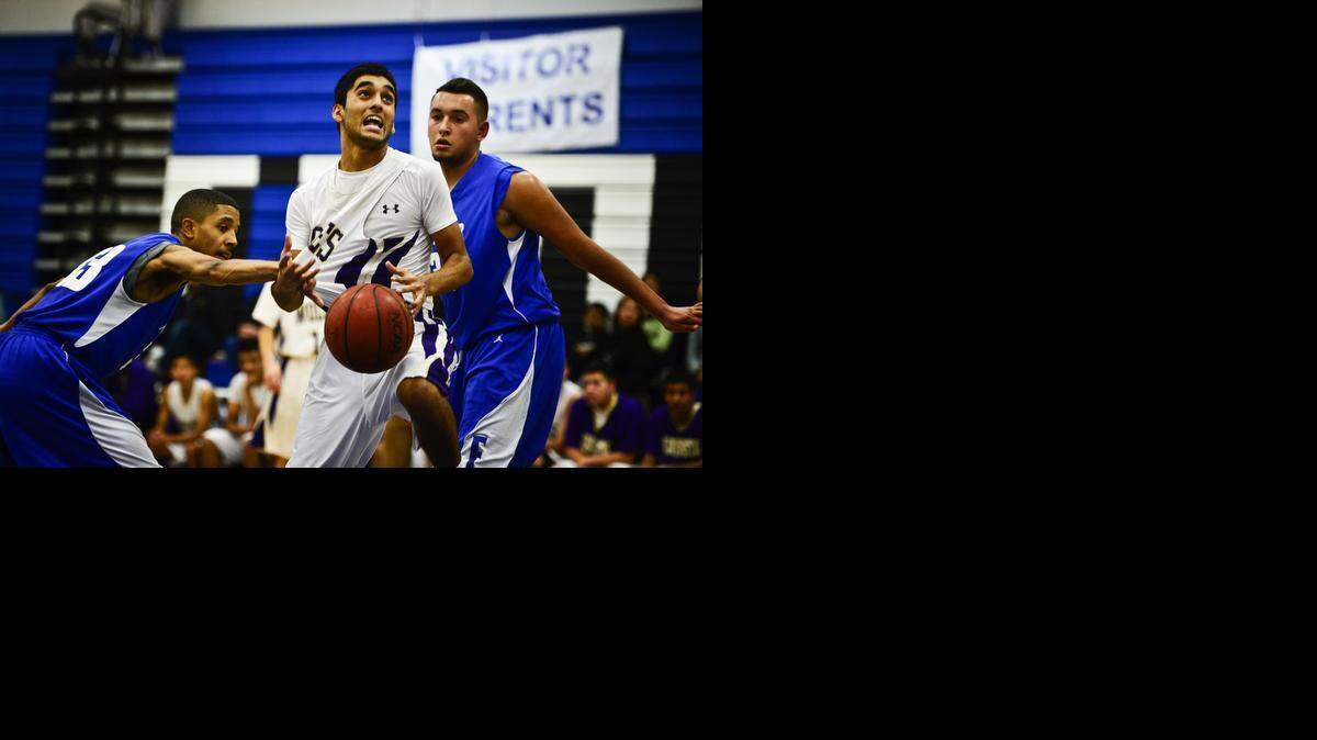 
Livingston’s Anthony Deol, who scored nine points, finds tough going between two Atwater defenders. “We’re playing a little better on defense and the kids are executing a lot better,” Wolves coach Ricardo Aguilar said. “We’re starting to believe we can play, and that’s a good thing.”
