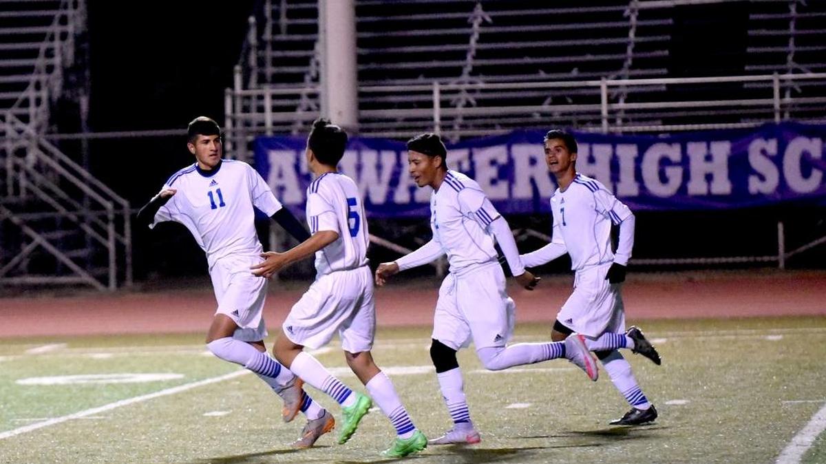 Atwater senior Omar Duran (11) celebrates with teammates after scoring the only goal in a 1-0 victory over Lincoln on Thursday night.