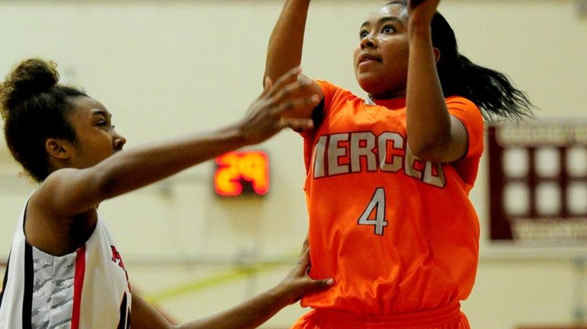 Merced's Lexi Thompson drives for a layup against a Beyer defender Thursday at the Lady Cougars Classic.