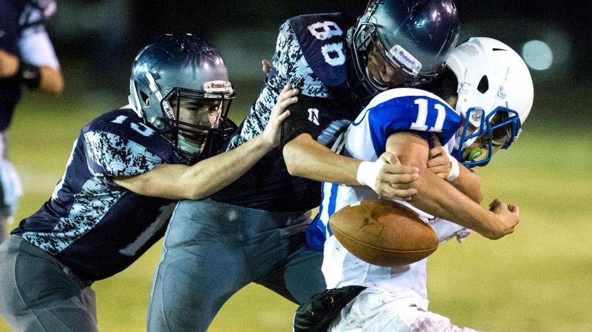Stone Ridge Christian sophomore Ian Mckee (88) hits Brookside Christian senior quarterback Isaiah Gomez (11) during a a Sac-Joaquin Section Division VII playoff game at Castle Field in Atwater, Calif., on Thursday, Nov. 9, 2017. Stone Ridge Christian beat Brookside Christian 50-13.