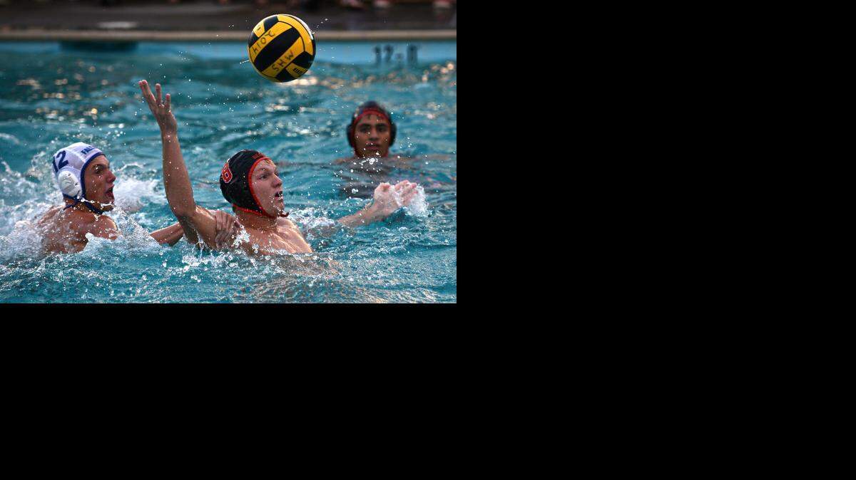 The play of senior Josh Fluetsch (8) helped Merced rally to win the Central California Conference title, including seven goals against Golden Valley.<137>-gamloses the ball during a water polo match against Atwater at Merced High School in Merced, Calif., Thursday, (09-25-14). Atwater beat Merced 16-15 in double overtime.<137>