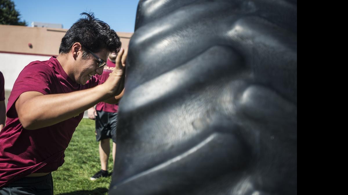 
Golden Valley High School junior Daniel Lopez, flips a tire while working out with the football team at Golden Valley High School in Merced, Calif., Wednesday, July 8, 2015. The lineman are preparing for the Hogg Challenge which will consist of offensive and defensive lineman from six schools competing in various strength and agility drills at Golden Valley on Friday, July 10.
