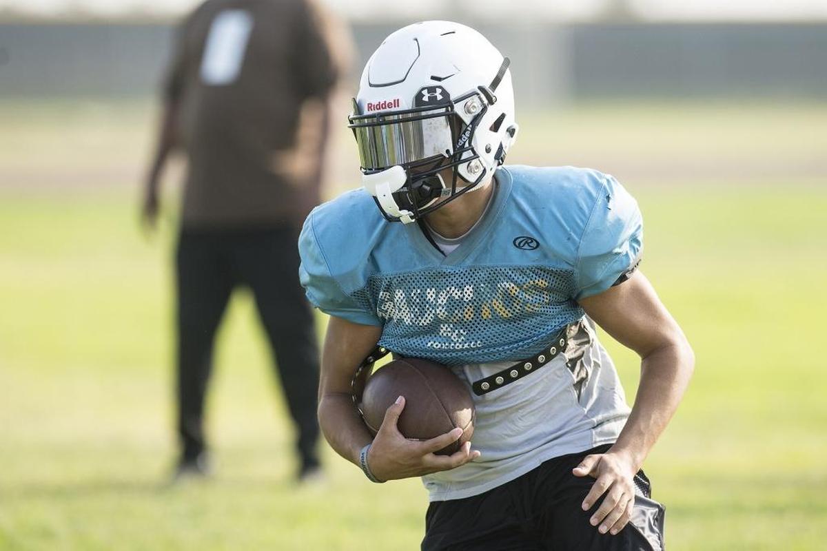 El Capitan’s Kevin Reid rushes the ball during football practice at El Capitan High School in Merced, Calif., on Wednesday, Aug. 8, 2018.