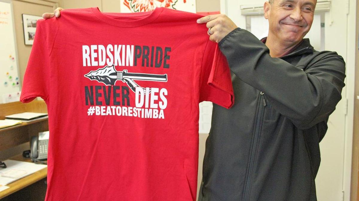 Gustine vice principal Adam Cano holds up the T-shirt that will be worn at the Battle for the Chief against Orestimba on Friday night.