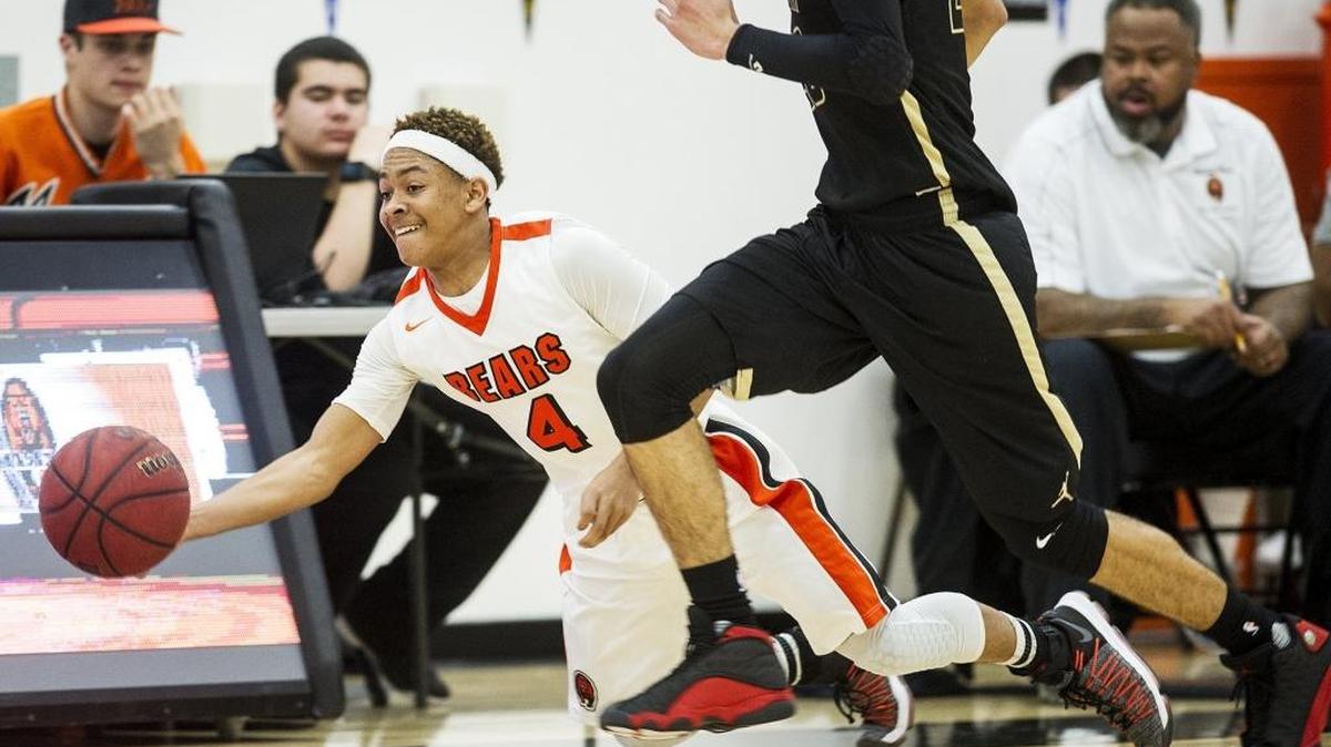 Merced sophomore Desmond Thompson (4) dives to keep the ball in play during a game against Buhach Colony at Merced High School in Merced, Calif., on Friday, Jan. 26, 2018. The Bears beat the Thunder 64-49.