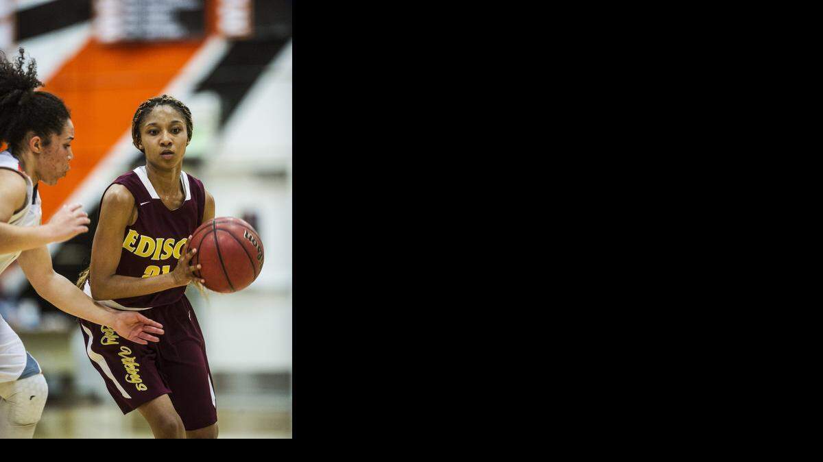 
Edison senior Marcellieya Hardin (21) moves the ball around the perimeter during a game against Merced in the first round of the Sac-Joaquin Section Division 1 playoffs at Merced High School in Merced, Calif., Friday, Feb. 20, 2015. The Bears beat the Vikings 51-47.
