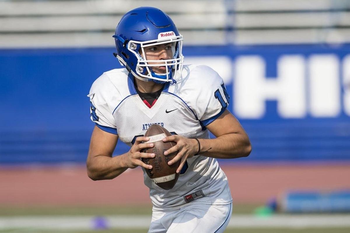 Atwater quarterback Isaiah Deleon rolls out of the pocket during football practice at Atwater High School in Atwater, Calif., on Tuesday, July 31, 2018.
