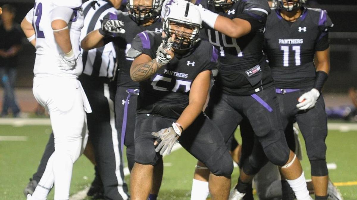 C.J. Samifua holds up two fingers after sacking the Madera South quarterback in two consecutive plays Fri., Aug. 25, 2017 at home at Veterans Stadium in Los Banos.
