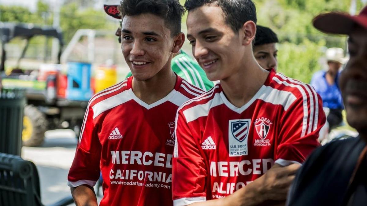Merced Atlas Soccer Academy players Axel Ramirez, 15, left, and Alfonso Ocampo-Chavez, 14, smile after signing with the Seattle Sounders of Major League soccer, to attend the team’s youth academy, at McNamara Park in Merced, Calif., Saturday, July 30, 2016.