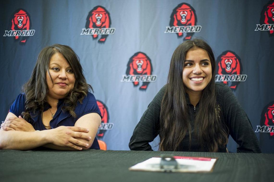 Merced's Ciara Colon, right, sits with her mother Lupe, left during a signing ceremony at Merced High School in Merced, Calif., on Wednesday, April 18, 2018. Colon has signed her letter of intent to attend and run cross country at California State University, Stanislaus.