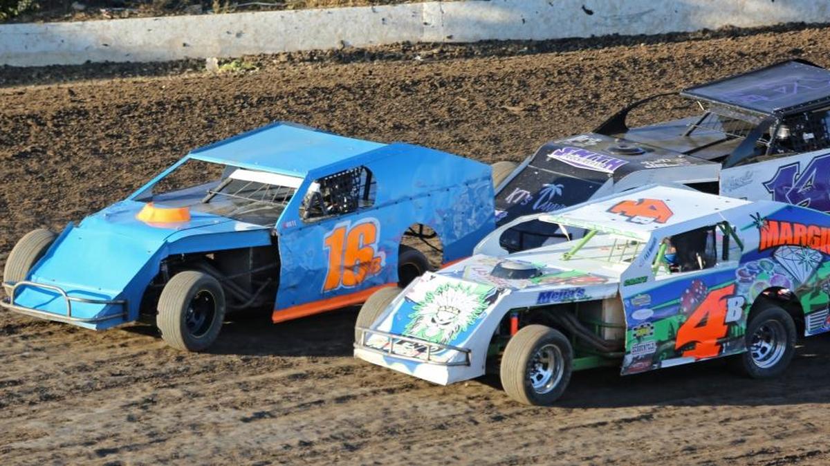 Championship point leader and defending track champion Randy Brown of Chowchilla (16B) is challenged by Bruce "Bubba" Nelson (4) of Winton as Ryan Porter of Atwater closes in on the fourth turn of Merced Speedway. Nelson is in third place for this year's championship, Porter is in fourth, with two races left for the season. (Photo by Mike Adaskaveg)