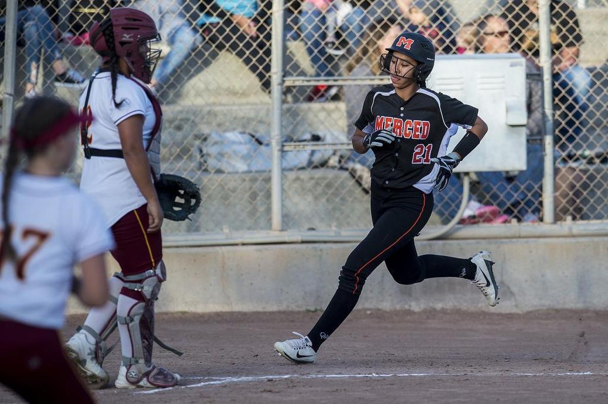 Merced sophomore Jewels Perez (21) scores a run during a game against Golden Valley at Joe Herb Park in Merced Calif., on Thursday, April 12, 2018. The Cougars beat the Bears 3-2.