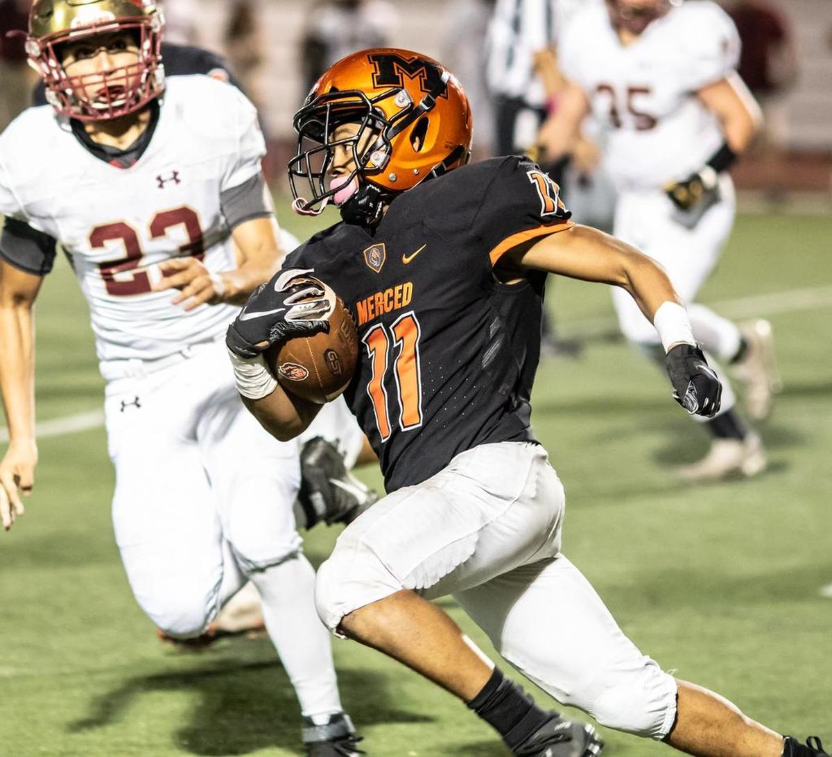Merced running back Desmond Thompson runs up field during the 25th annual Battle for the Mayor’s Cup on Friday night at Veterans Stadium. Thompson went over the 1,000-yard mark on the season with 126 rushing yards.