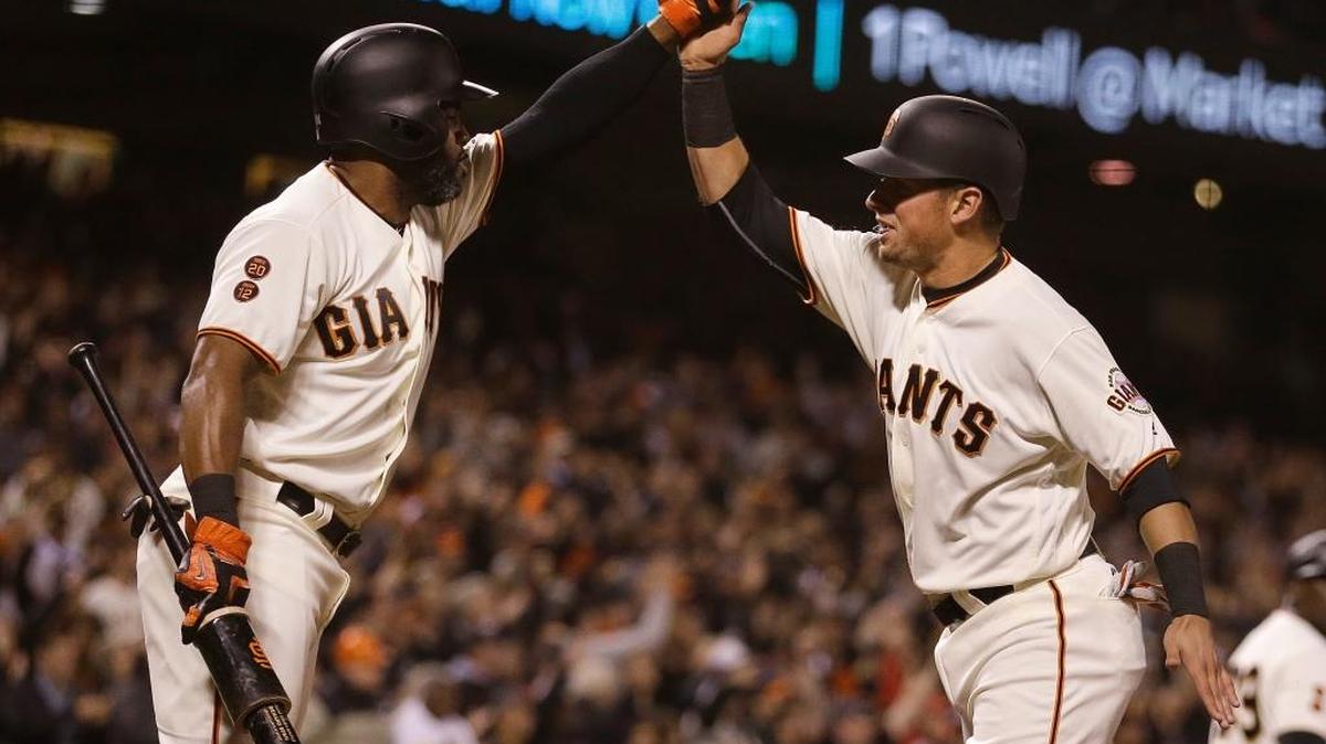 Joe Panik, right, and Denard Span of the Giants celebrate after they each scored on a throwing error in the sixth inning on Thursday, Sept. 29, 2016, in San Francisco.