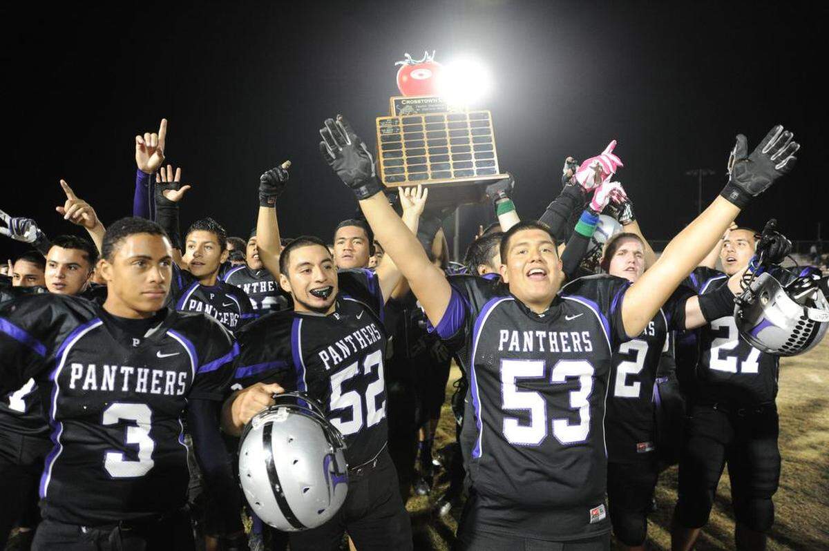 Pacheco’s player hoist the Morning Star Crosstown Clash Trophy for the first time on Friday (Nov. 8, 2013) at Veterans Stadium at Pacheco.