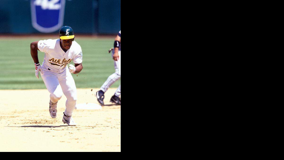 Hall of Famer Rickey Henderson, shown with the A’s in 1998, believes he can not only help Coco Crisp improve on the base paths, but also with his transition to left field.