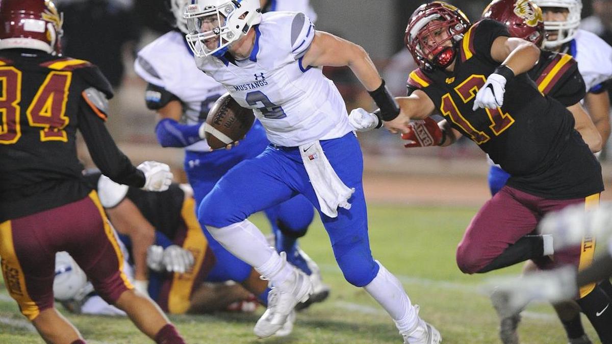 Mountain House High quarterback, Jesse Jordan, center, runs up the middle of the field in the second quarter against Los Banos Sept. 28, 2018 at Loftin Stadium in Los Banos.