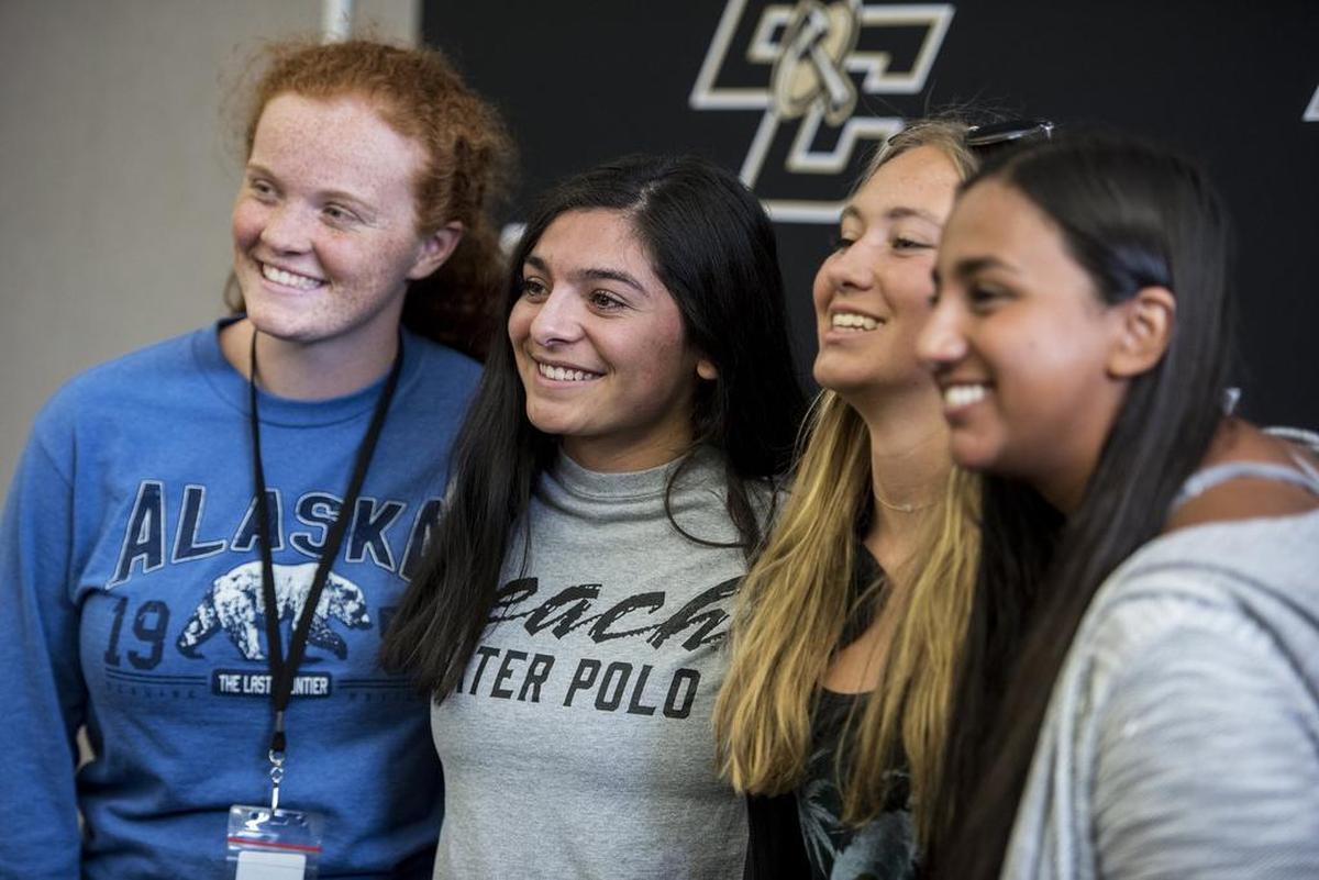 Buhach Colony senior Pamela Solano, second from left, poses for photos with friends during a ceremony at Buhach Colony High School in Atwater, Calif., on Wednesday, April 11, 2018. Solano has verbally committed to play water polo at California State University, Long Beach.