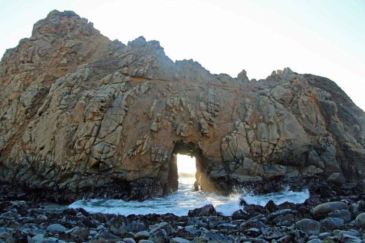 At Pfeiffer Beach in Big Sur, California, it's worth the $10 entrance fee to enjoy the beach and marvel at the tunnel the waves have eroded through Keyhole Rock.