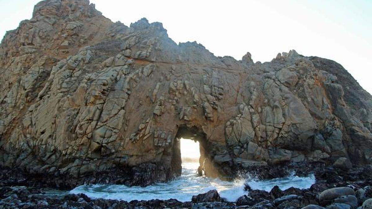 At Pfeiffer Beach in Big Sur, California, it's worth the $10 entrance fee to enjoy the beach and marvel at the tunnel the waves have eroded through Keyhole Rock.