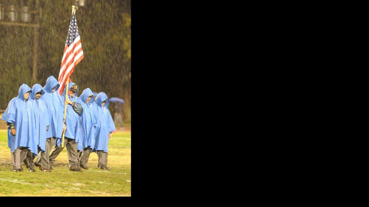 
Los Banos VFW and American Legion post the colors Fri., Oct. 31 in the pouring rain before the Los Banos Tigers play Central Valley of Ceres.

