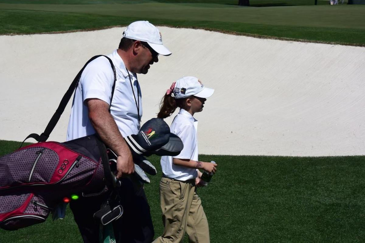 Chowchilla's Asterisk Talley competes during the National Drive, Chip and Putt Finals at Augusta National Golf Club. Her father Jim Talley carries her bag.